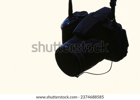 Black camera on the white background closeup of photo with soft focus