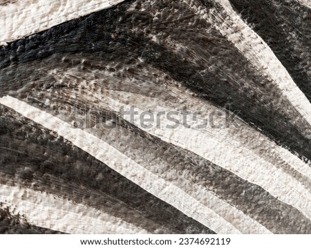 Abstract black and white paint background. Artistic background made of painted cement wall. Black and white paint brush strokes on  aged concrete cement wall. Paint brush strokes textured wall.