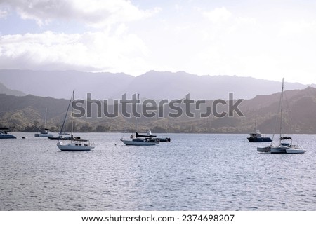 Yachts and boats anchored in Hanalei Bay with Na Pali coast in the background, Kauai, Hawaii