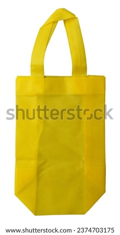 a yellow non-woven fabric tote bag isolated by a white background. eco-friendly bag made of polypropylene
