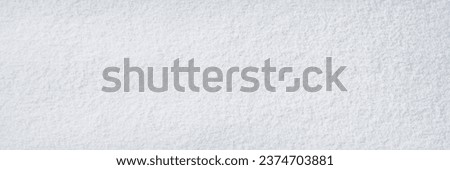 Natural snow texture. Smooth surface of clean fresh snow. Snowy ground. Winter background with snow patterns. Perfect for Christmas and New Year design. Closeup top view. Royalty-Free Stock Photo #2374703881