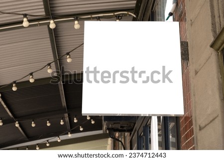 Mockup Template or background texture of a Blank White Square Shop Sign Attached to Building - for Cafe or Restaurant.