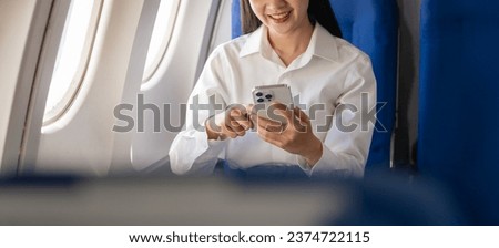 Texting on mobile chat app, Thoughtful asian people female person onboard, airplane window, perfectly capture the anticipation and excitement of holiday travel. chinese, japanese people.