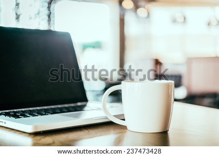 Coffee cup , laptop in coffee shop - vintage effect style pictures