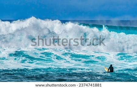 Surfer Looking Large Wave Waimea Bay North Shore Oahu Hawaii. Waimea Bay is famous for big wave surfing. On this day, waves were 15 to 20 feet high.  Royalty-Free Stock Photo #2374741881