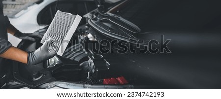 Auto mechanic holding old car air filter pollution to checking cleaning and replacing new for fix heat car air conditioner service maintenance. Royalty-Free Stock Photo #2374742193