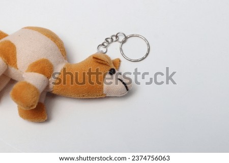 Key chain shaped like a camel, brown and cream. Cute and unique. Isolated white.