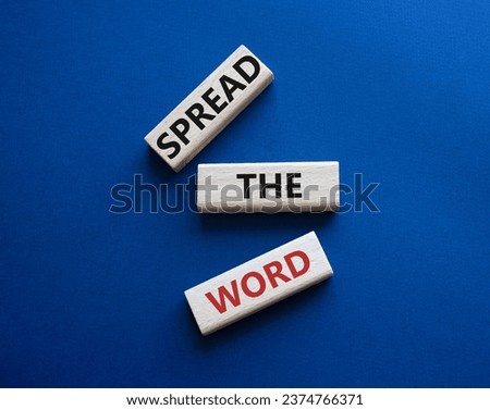 Spread the Word symbol. Concept wordsSpread the Word on wooden blocks. Beautiful deep blue background. Business and Spread the Word concept. Copy space.