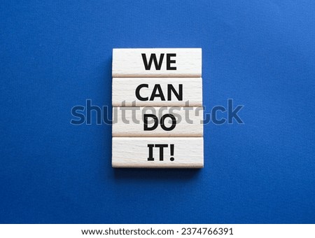 We can do it symbol. Concept words We can do it on wooden blocks. Beautiful deep blue background. Business and We can do it concept. Copy space.