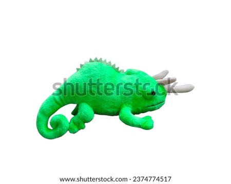 Green chameleon doll on white background