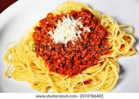 A picture of fresh spaghetti served on a white plate