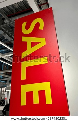 Vertical sale sign at the entrance to a store