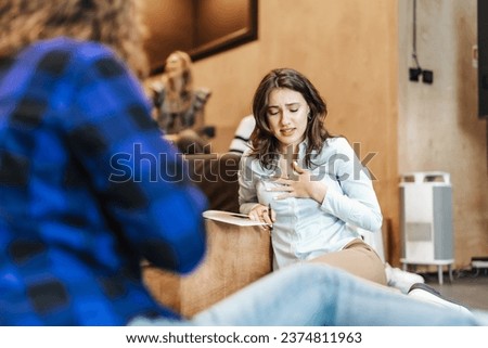 Female employee apologizing to her colleague for the mistake she did at work. Royalty-Free Stock Photo #2374811963