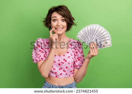 Photo of pretty tricky lady wear pink blouse finger lips rising money cash fan isolated green color background