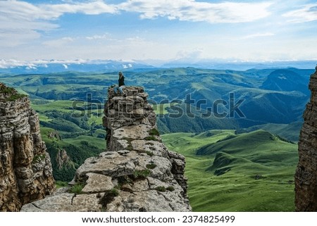 A girl on the background of the mountains and the Bermamyt plateau in Russia. June