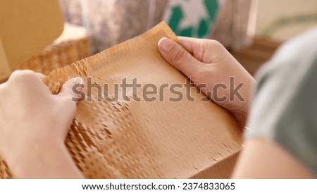 Eco vendor go green packaging parcel carton box in net zero waste store asian seller retail shop. Earth care day small SME owner asia people wrap reuse brown paper pack gift reduce plastic free order. Royalty-Free Stock Photo #2374833065