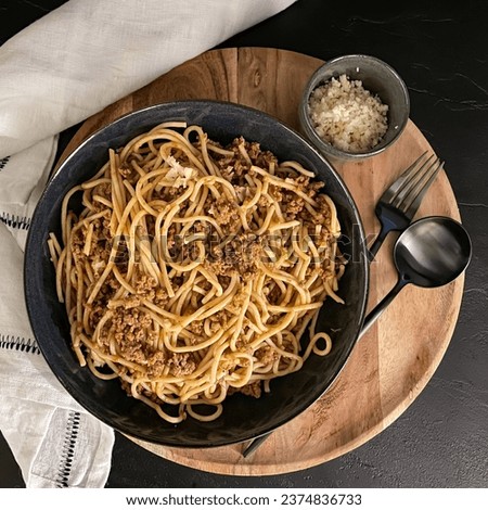 Greek spaghetti with mince meat and cheese, similar to bolognese, on a dark background with mystic light