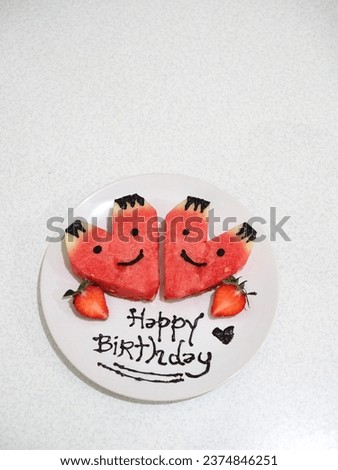 watermelon character with strawberryand happy birthday's text on white plate and white background. isolated