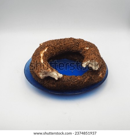 Turkish bagel on a blue glass plate on a white background