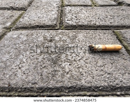 Cigarette butts thrown carelessly on the sidewalk