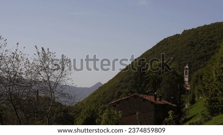 Italian Landscape: Alpine village. Small treasure in Bergamo province alpine area. Val Brembilla rural hamlet. Church, Tower bell, rural narrow streets, landscape. Autumn season