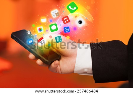 Hand holding smartphone with colorful app icons concept