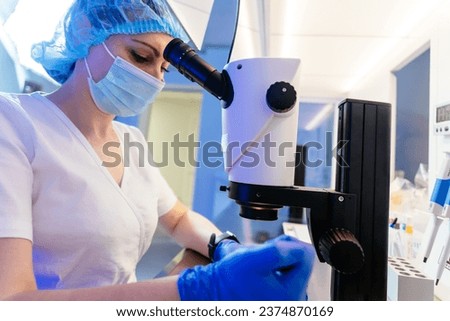 Real process of female embryologist, assisted reproductive technologies, fertilization vet examining sample artificial insemination infertility treatment in embryology laboratory. Royalty-Free Stock Photo #2374870169