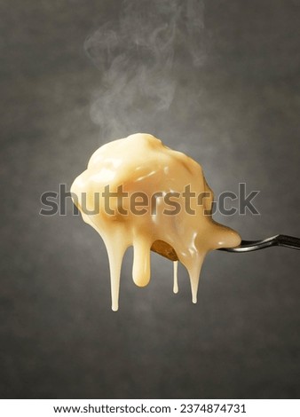Hot cheese dripping from the forks in a close up view  Royalty-Free Stock Photo #2374874731