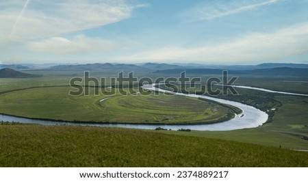 Summer natural landscape with hills, green field, blue sky and clouds from a bird's eye view.Photos of the Republic of Mountain Altai in summer, aerial photography, Russia, Siberia