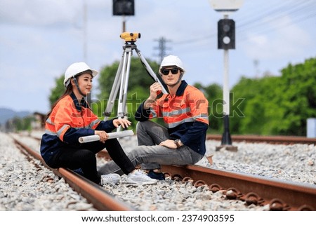 portrait of Engineer in uniform sitting on Raiway, concept surveying construction worker on Railway site. 