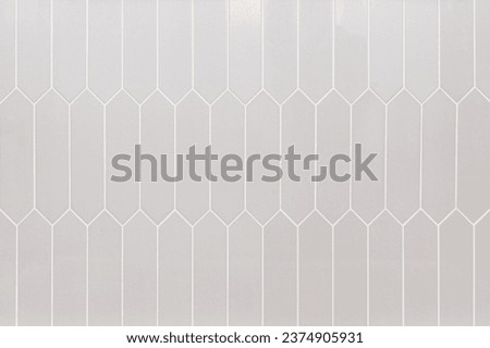 Tan picket tiles with white grout used for showers, flooring, and kitchen backsplashes. Royalty-Free Stock Photo #2374905931