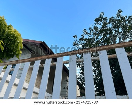 House fence with bright blue sky