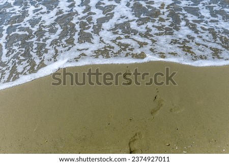 footprints on a Mediterranean beach