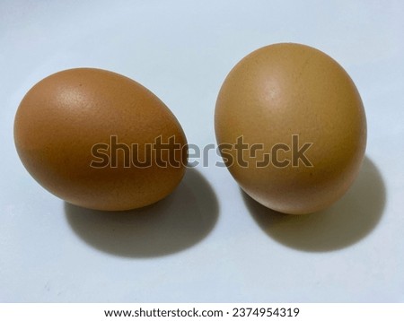 two chicken eggs ready to be cooked