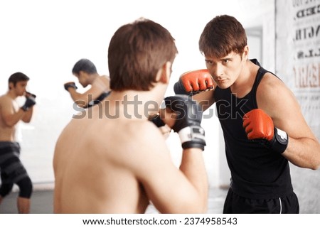 Man, fighting and martial arts training for self defense techniques with sparring partner at dojo. Male person, athlete or fighter in kick boxing, karate or MMA for jujitsu match, sports or face off Royalty-Free Stock Photo #2374958543