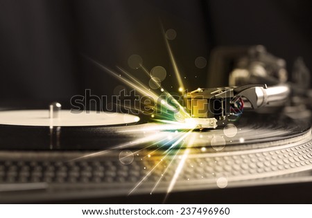 Music player playing vinyl with glow lines comming from the needle concept on background Royalty-Free Stock Photo #237496960