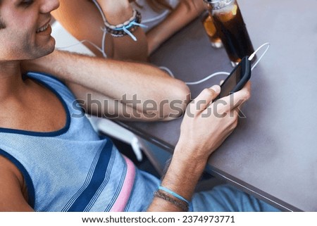 Smile, cafe and a man with a phone for music, listening to a podcast or watching a video. Happy, social media and a person with a mobile for a radio app, sound or streaming audio at a restaurant