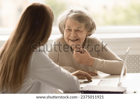 Smiling female senior patient get professional medicare in private hospital, tell about health complaint. General practitioner have consultation meeting with adult client. Eldercare, medicine, health Royalty-Free Stock Photo #2375011921