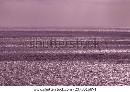 Beautiful view and sea scape over a  striped Skagerrak Sea, a light house and islands along the coast line. Cloudy skies causing the sun to highlight areas on the sea level. Royalty-Free Stock Photo #2375016891