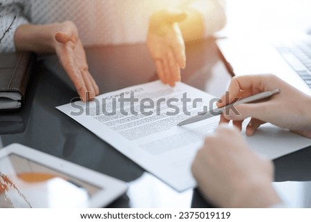 Businesswoman lawyer pointing into contract special points admitting something for colleague or client at meeting. Business people teamwork and partnership