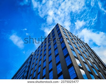 Architectural photography of a striking blue building in dynamic 3-point perspective. Urban skyline. Modern cityscape. Structural design.