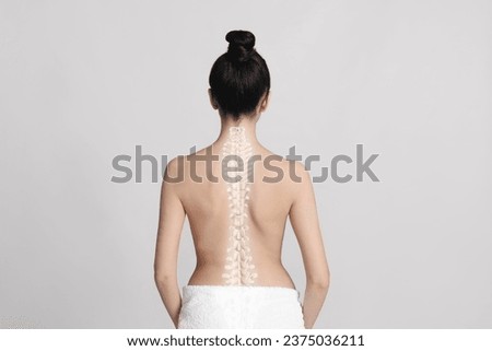 Woman with healthy back on light background. Illustration of spine Royalty-Free Stock Photo #2375036211