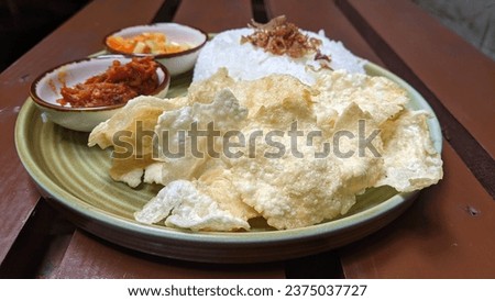 Closeup picture of belinjo chips that also called as emping in Indonesia, as the side dish  with blurred background.