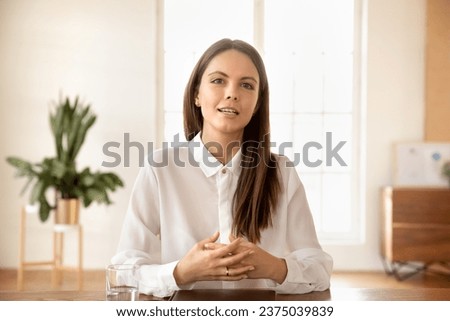 Confident pretty young business blogger woman speaking on online streaming, giving learning webinar. Online teacher, freelance professional, influencer head shot portrait Royalty-Free Stock Photo #2375039839