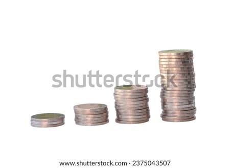 Silver coins in separated stacks are isolated on white background with clipping path. Money growth concept in investment and saving money