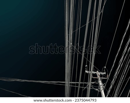 High electrical pole tower line at night
