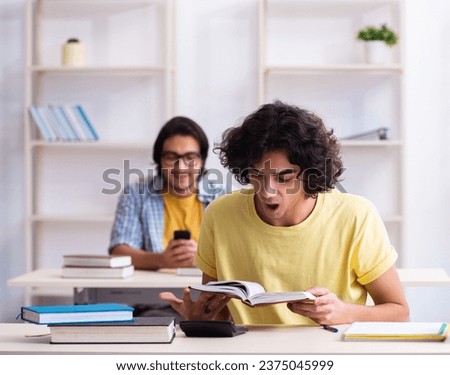 Two male students in the classroom Royalty-Free Stock Photo #2375045999