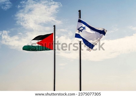 Concept of a Conflict between Isreal and the Palestinian. flags of Palestine and Israel on a blue background of cloudy sky. negotiations between Palestine and Israel concept. Royalty-Free Stock Photo #2375077305