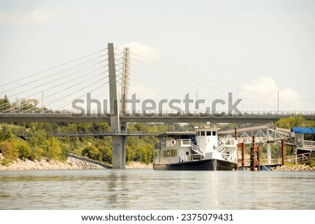 tourist paddlewheel boat on river in city Royalty-Free Stock Photo #2375079431