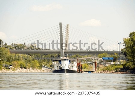 tourist paddlewheel boat on river in city Royalty-Free Stock Photo #2375079435